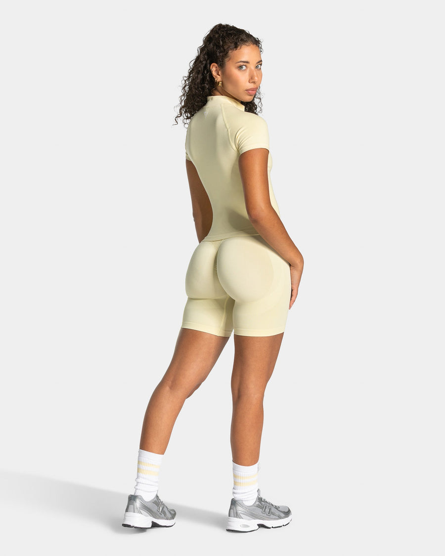 Haut à manches courtes zippé Lift « Butter Yellow »